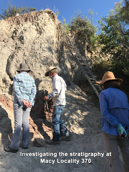 Crew looking at layers of sediment